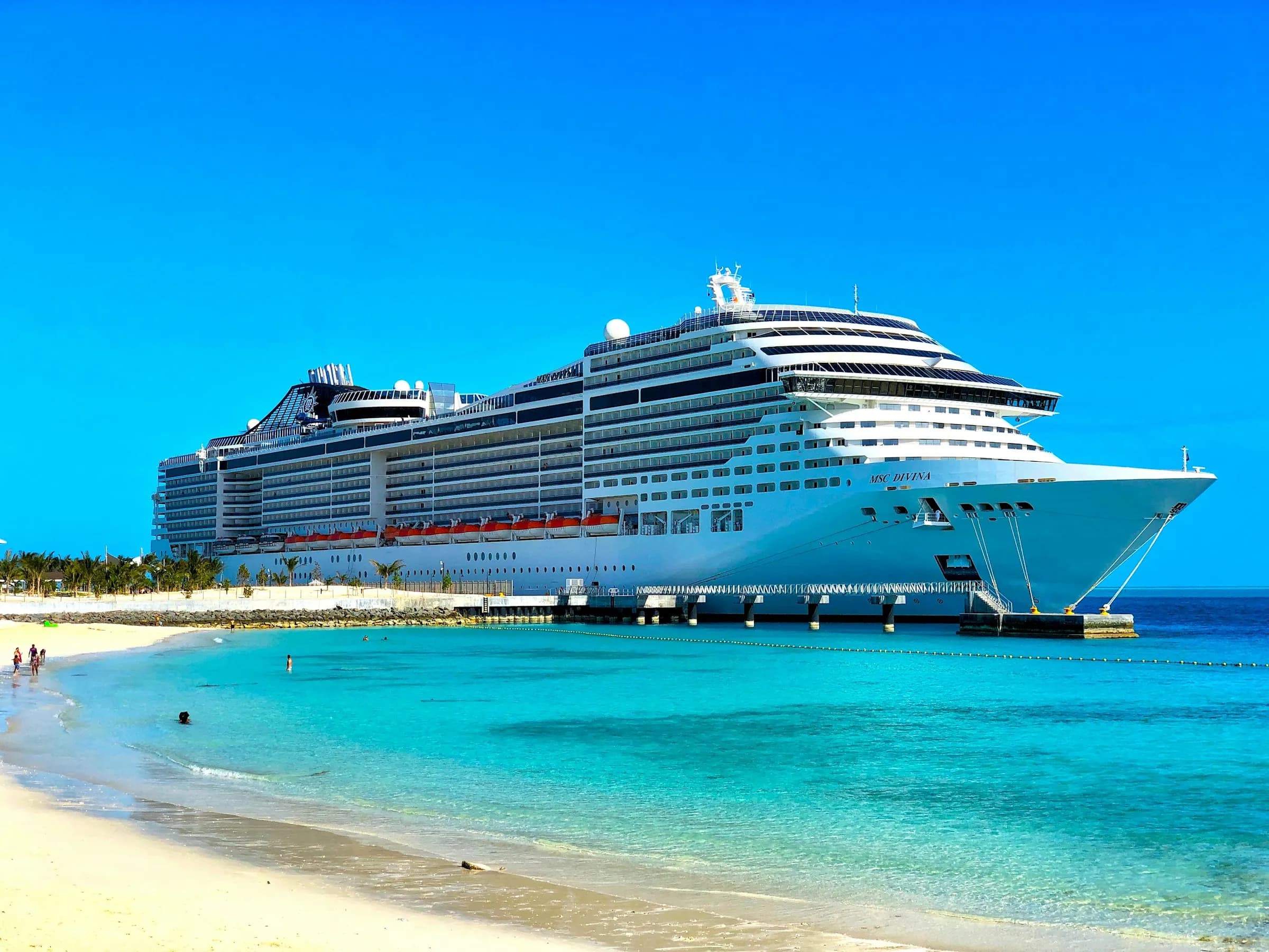 A white cruise ship sailing under a clear sky