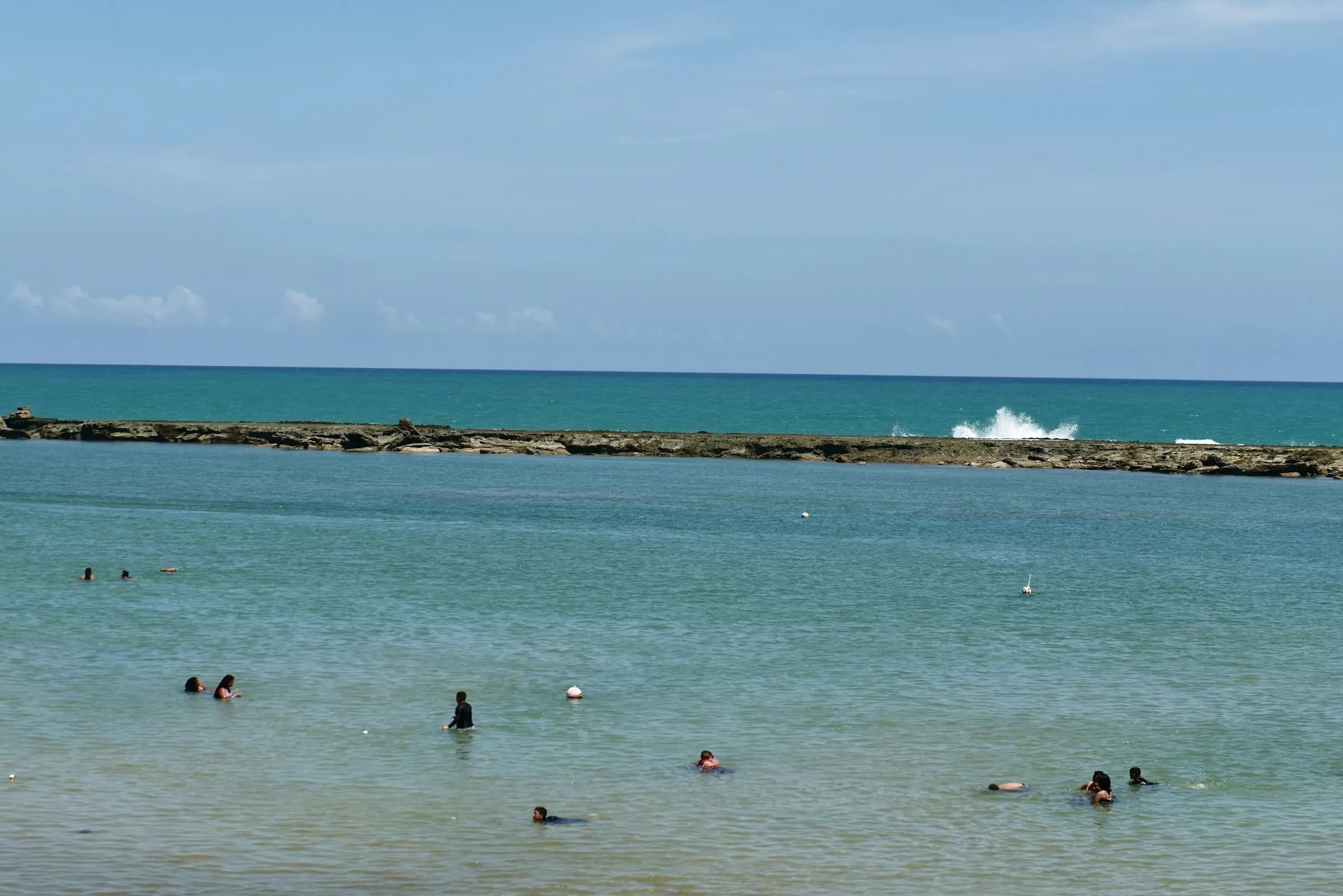 People swimming in Maceió's natural pools